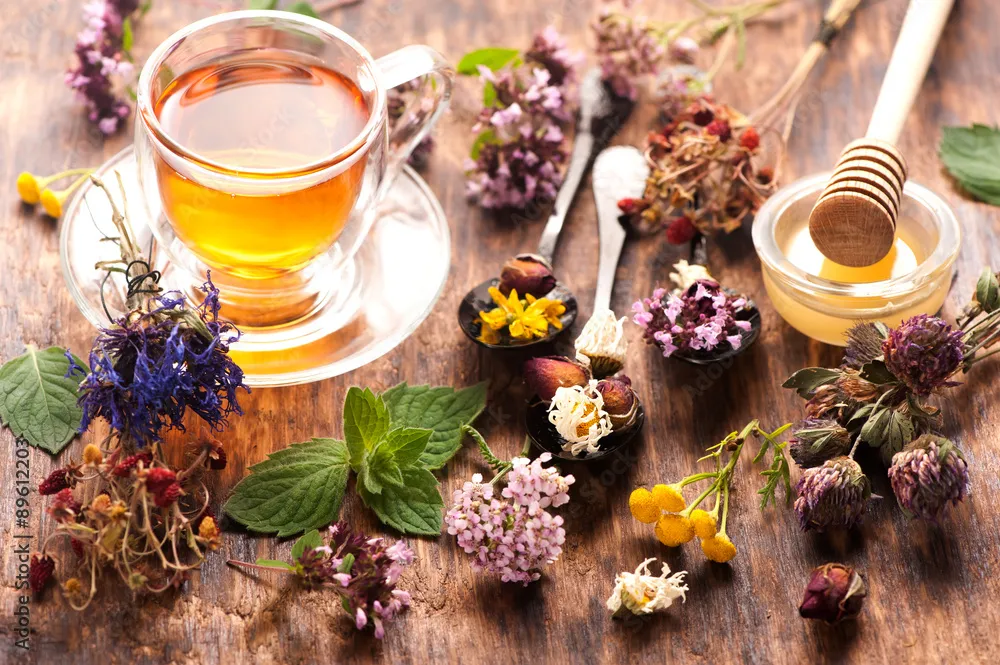 Three tins of loose herbal tea on a wooden counter